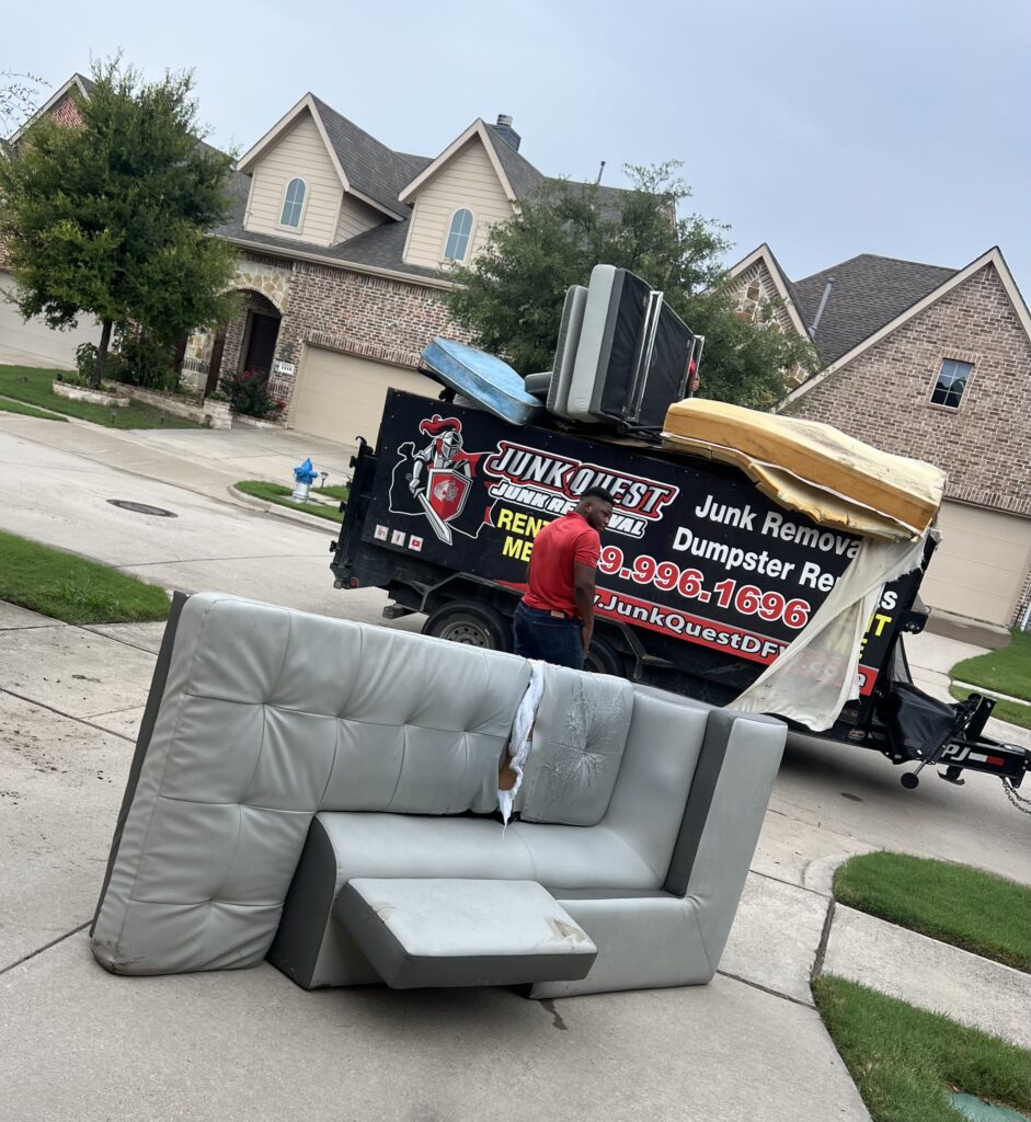 Junk Quest crew preparing to remove a sectional couch during a junk removal service — professional furniture pickup and hauling for North Texas homeowners.