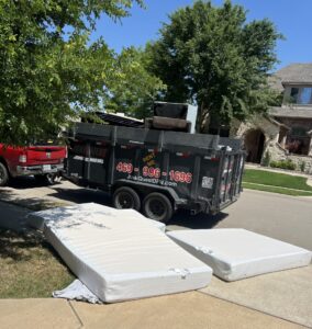 Junk Quest trailer loaded with old mattresses during a mattress removal service in McKinney, TX — eco-friendly junk hauling and disposal for local homeowners.