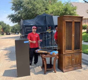 Junk Quest crew handling a furniture pickup in McKinney, TX — professional junk removal team hauling large household items for local homeowners.