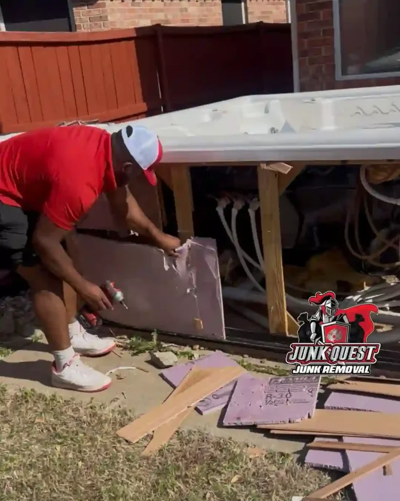 Junk Quest crew cutting and dismantling a hot tub during a demolition job in McKinney, TX