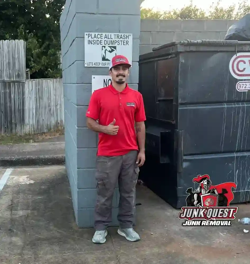 Junk Quest crew member standing in front of a 20-yard dumpster after a junk removal job in McKinney, TX