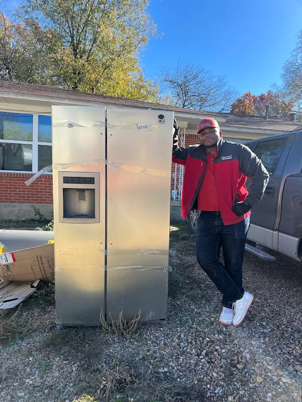 Junk Quest Removal team member with refrigerator during appliance removal service in North Dallas