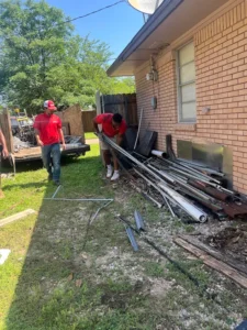 Junk Quest Removal crew removing metal construction debris during residential construction cleanup in North Dallas