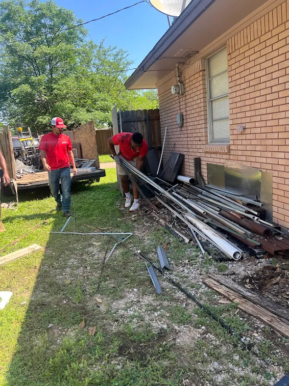 Junk Quest Removal crew removing metal construction debris during residential construction cleanup in North Dallas