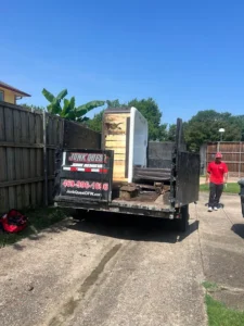 Junk Quest Removal truck hauling construction debris during a North Dallas cleanup