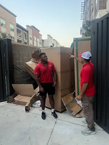 Junk Quest Removal team removing cardboard and debris during an estate cleanout in North Dallas