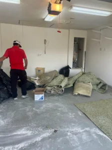 Junk Quest Removal team removing old carpet and debris during a garage cleanout in North Dallas