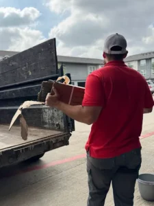 Junk Quest Removal team member hauling appliance materials during old appliance removal in North Dallas
