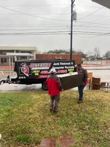 Junk Quest Removal crew carrying furniture during a professional property cleanout in North Dallas