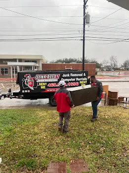 Junk Quest Removal crew carrying furniture during a professional property cleanout in North Dallas