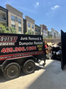 Junk Quest Removal truck providing garage junk removal services at a North Dallas apartment complex