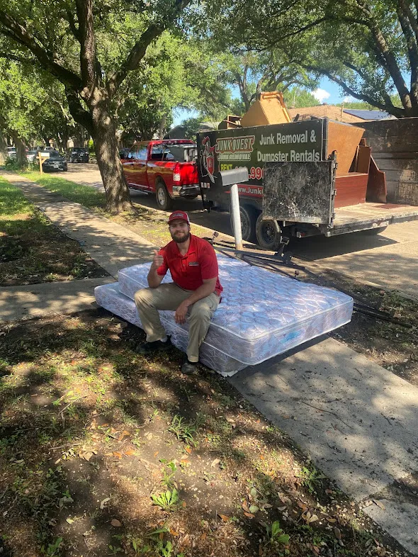 Junk Quest Removal team member with multiple mattresses ready for disposal in North Dallas
