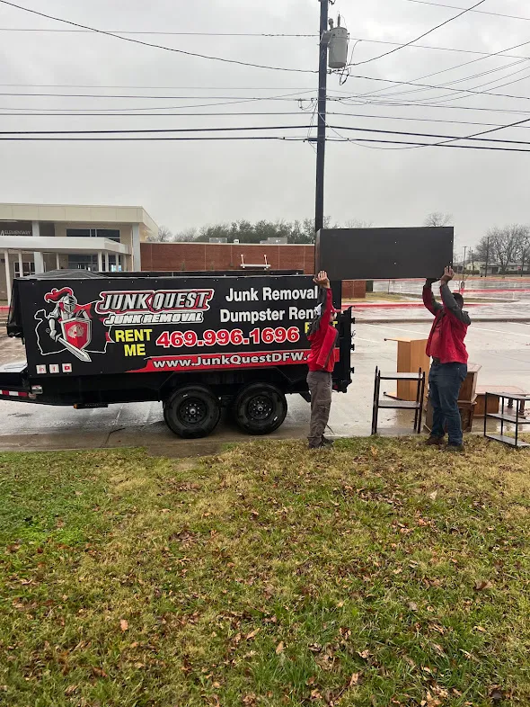 Junk Quest Removal crew loading old appliances and bulky items into a trailer during eco-friendly appliance removal in North Dallas