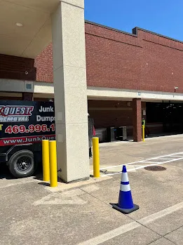 Junk Quest Removal truck staged at a warehouse loading dock during a professional warehouse cleanout in North Dallas
