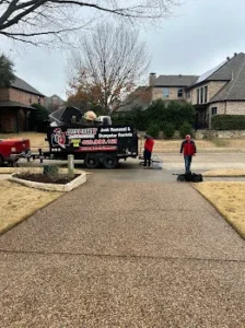 Junk Quest Removal crew loading furniture and debris during a foreclosure cleanout in a North Dallas neighborhood