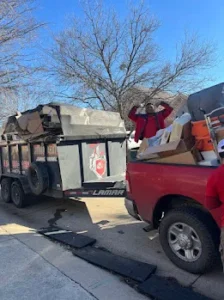 Junk Quest Removal crew loading furniture and debris during a foreclosure cleanout in North Dallas