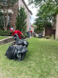 Junk Quest Removal crew collecting warehouse debris and scrap materials during a warehouse cleanout in North Dallas