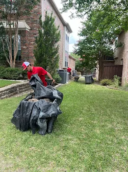 Junk Quest Removal crew collecting warehouse debris and scrap materials during a warehouse cleanout in North Dallas