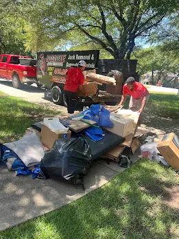 Junk Quest Removal crew loading retail fixtures boxes and debris during a professional retail cleanout in North Dallas