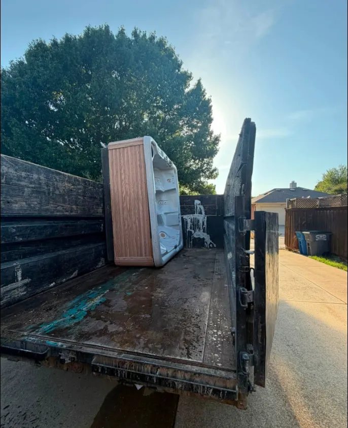 Junk Quest Removal crew loading hot tub during hot tub removal service in North Dallas