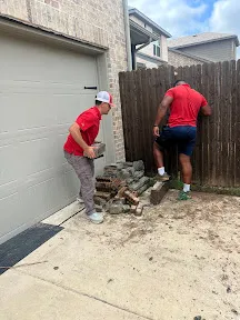 Junk Quest Removal team removing heavy debris and materials during storage unit cleanout service in North Dallas