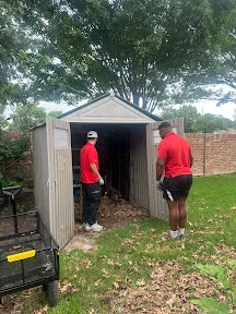Junk Quest Removal team clearing debris and clutter from storage space during professional cleanout in North Dallas
