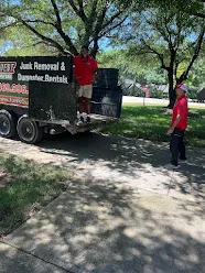 Junk Quest Removal crew loading large debris into trailer near park in North Dalla