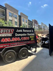 Junk Quest Removal trailer loaded with bulky debris outside apartment building in North Dallas