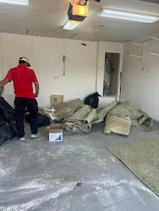 Junk Quest Removal crew removing debris and materials during garage cleanout service in North Dallas