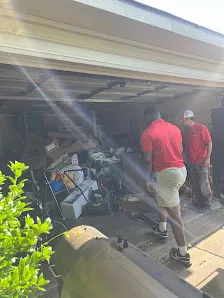 Junk Quest Removal crew assessing cluttered garage during basement and garage cleanout planning in North Dallas