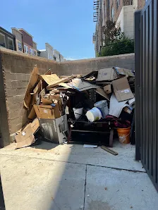 Junk Quest Removal crew assessing cluttered garage before hoarding cleanup preparation in North Dallas