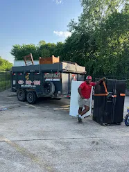 Junk Quest Removal crew performing residential junk hauling service loading debris and household items into trailer in North Dallas