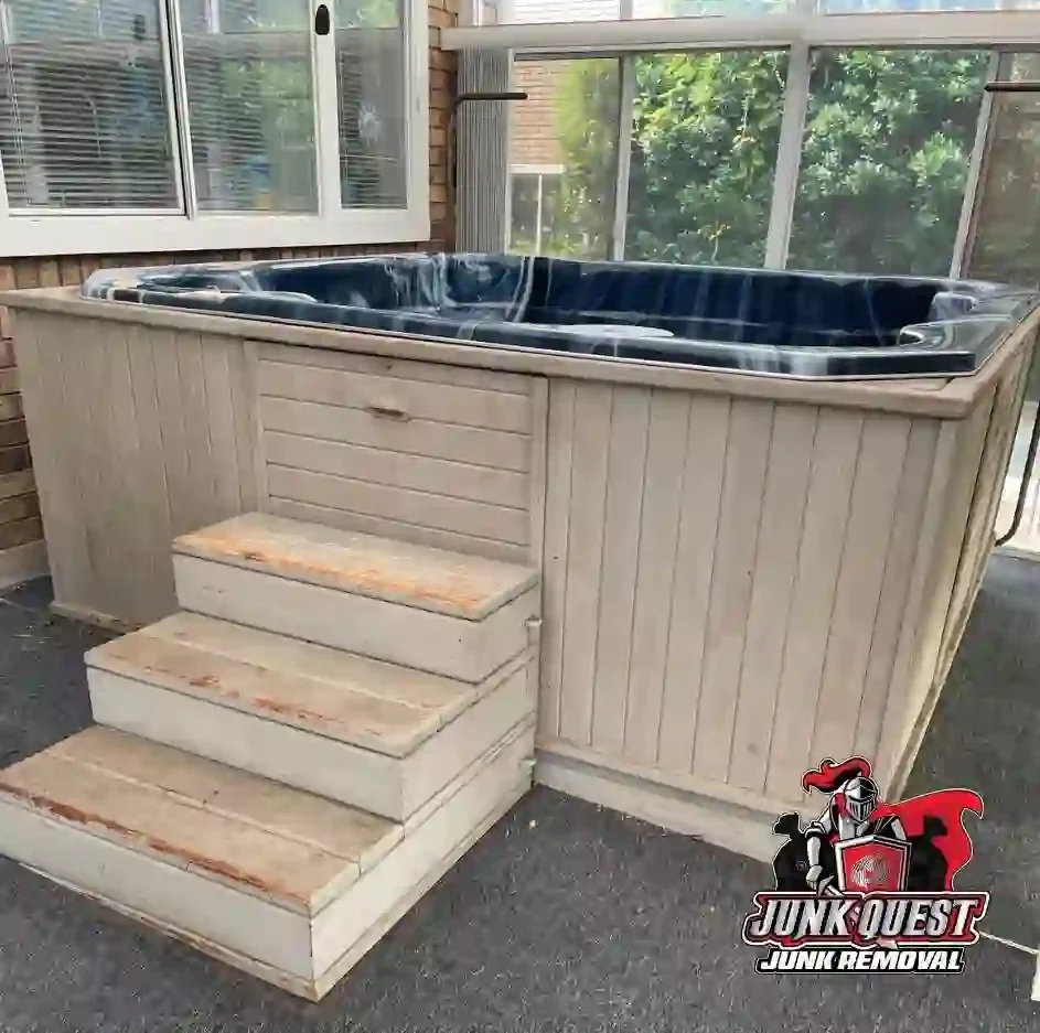 Junk Quest team removing an old hot tub from a backyard in Fairview, TX.