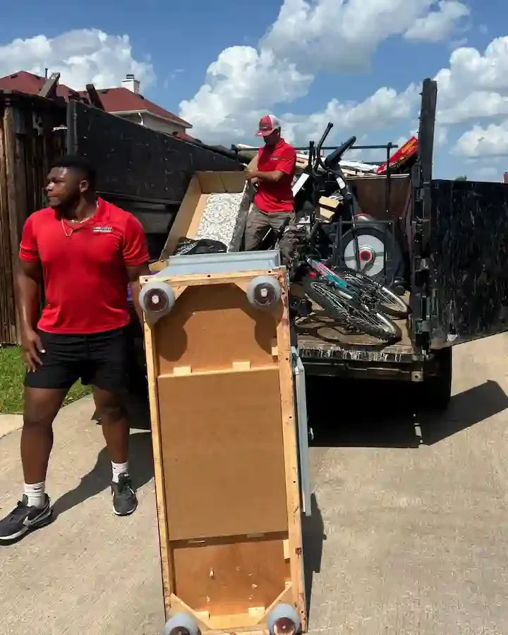 Junk Quest crew loading furniture and exercise equipment during a house cleanout.