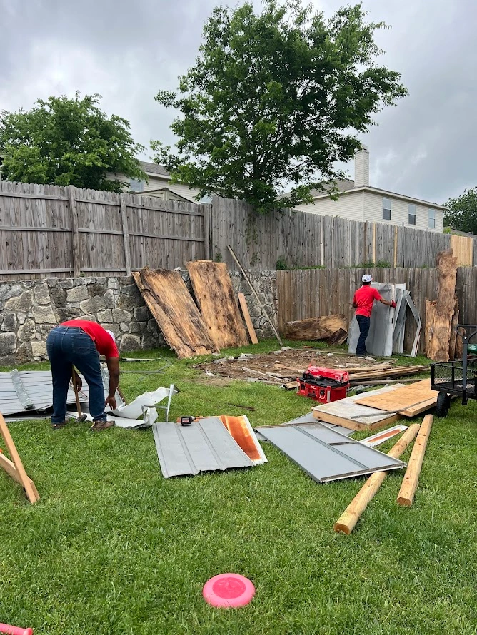 Junk Quest crew removing shed panels and materials during a shed removal job in Anna, TX.