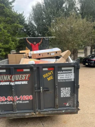 Junk Quest crew removing boxes and debris during an attic cleanout in North Dallas.