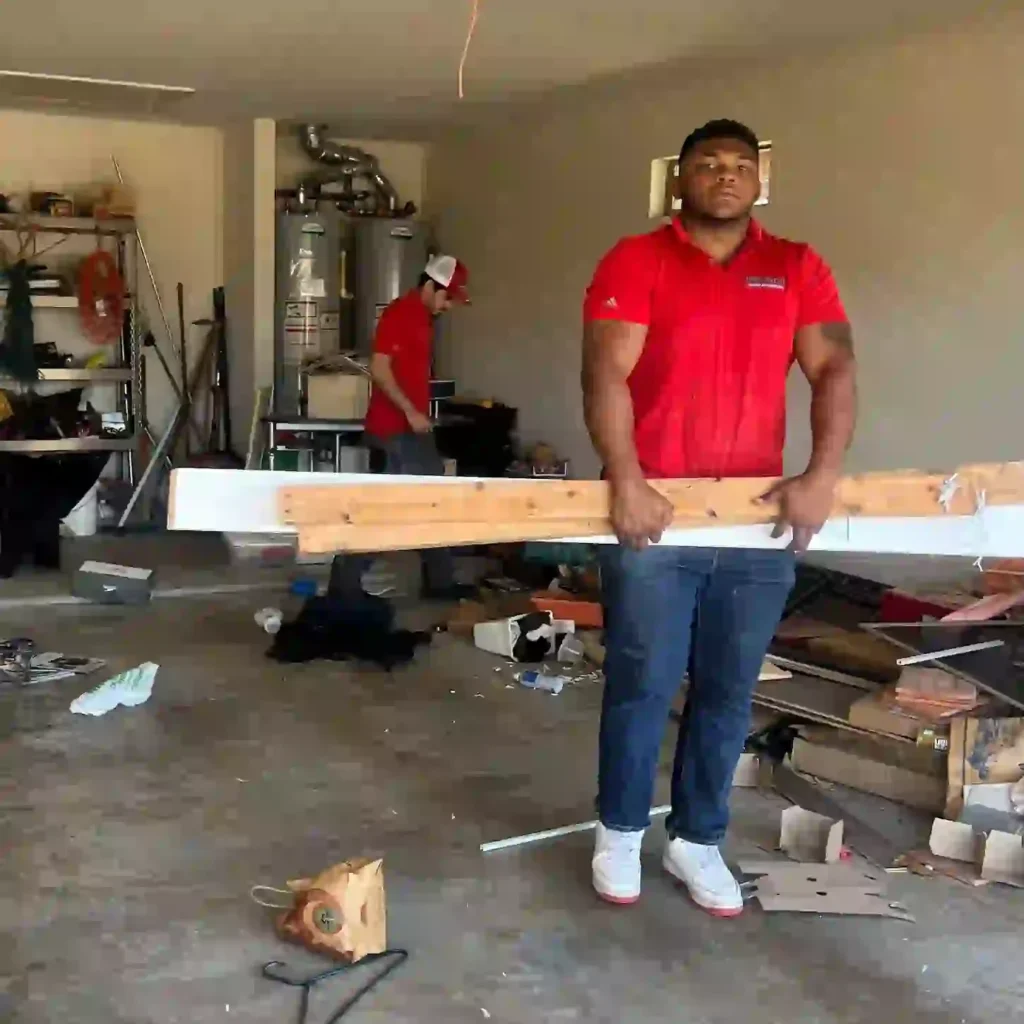 Junk Quest team hauling furniture and debris during a house cleanout in Fairview, TX.