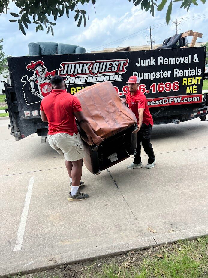 Junk Quest crew loading a recliner chair onto their branded trailer in Fairview, TX