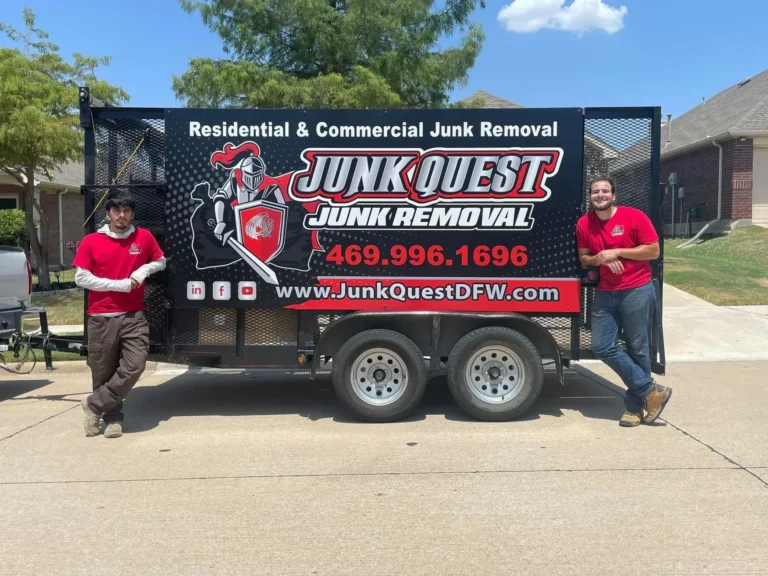 Junk Quest crew members standing beside their branded junk removal trailer