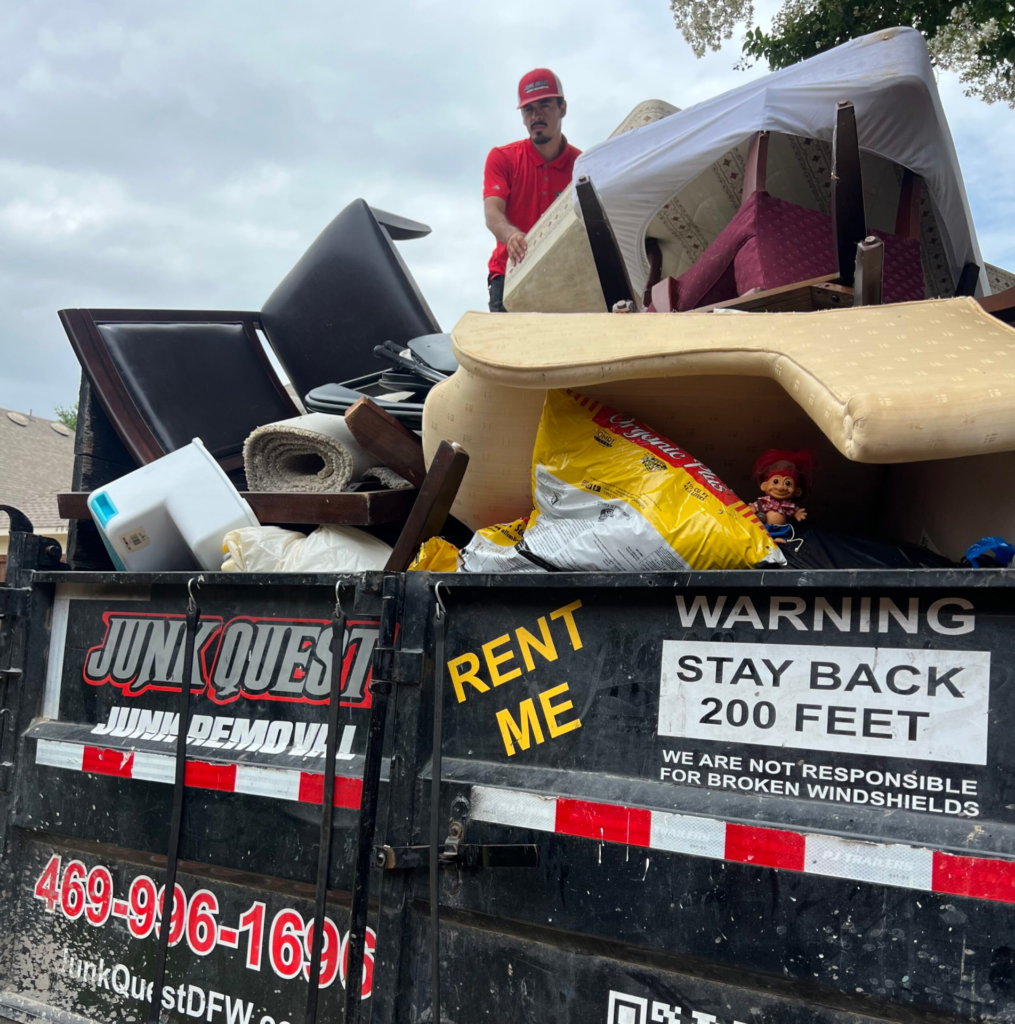 Junk Quest crew loading furniture and household items during a garage cleanout in North Dallas