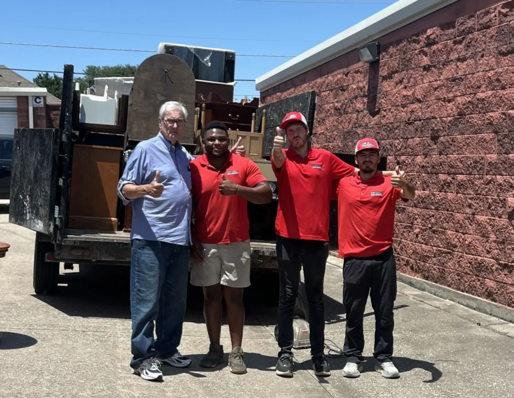 Junk Quest crew and satisfied customer with a loaded truck after a piano removal job