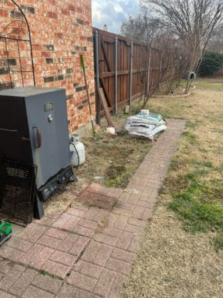 Junk Quest team removing an old riding lawn mower in North Dallas