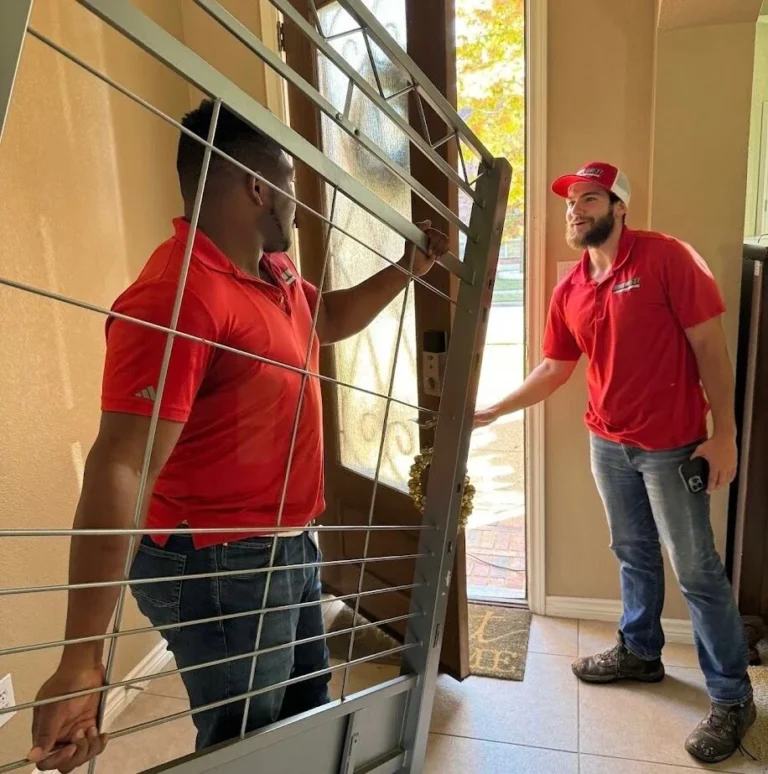 Junk Quest crew removing an old security door during an estate cleanout
