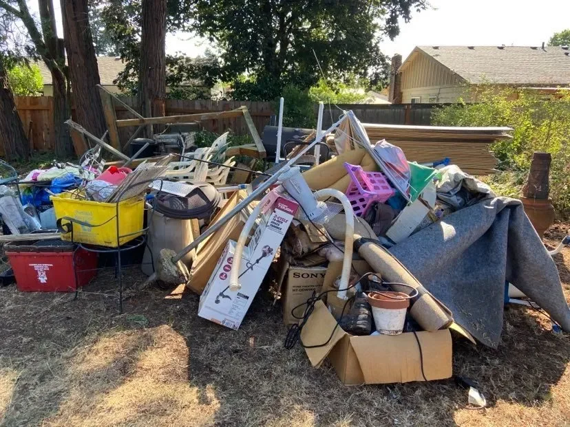 Pile of furniture and debris cleared during a property cleanout in North Dallas