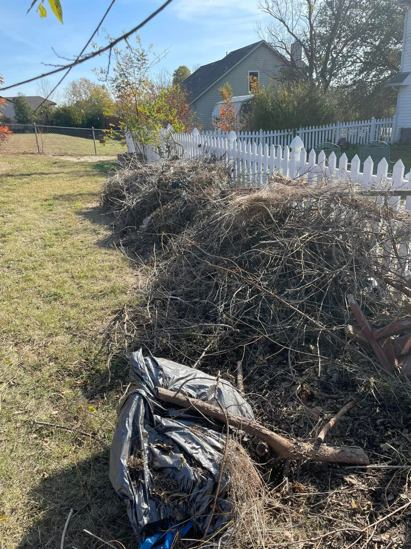 Pile of storm debris and fallen branches removed from a residential yard in North Dallas