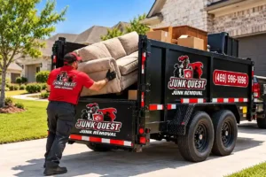 unk removal crew loading a couch into a trailer in a driveway in Anna, TX