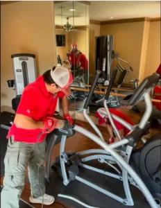 Junk Quest crew removing commercial gym equipment from an apartment fitness center in North Dallas