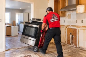 Old range being removed from a kitchen remodel in North Dallas, TX by a Junk Quest crew