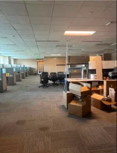 North Dallas office decommissioning with cubicles, chairs and boxes ready for removal before lease end
