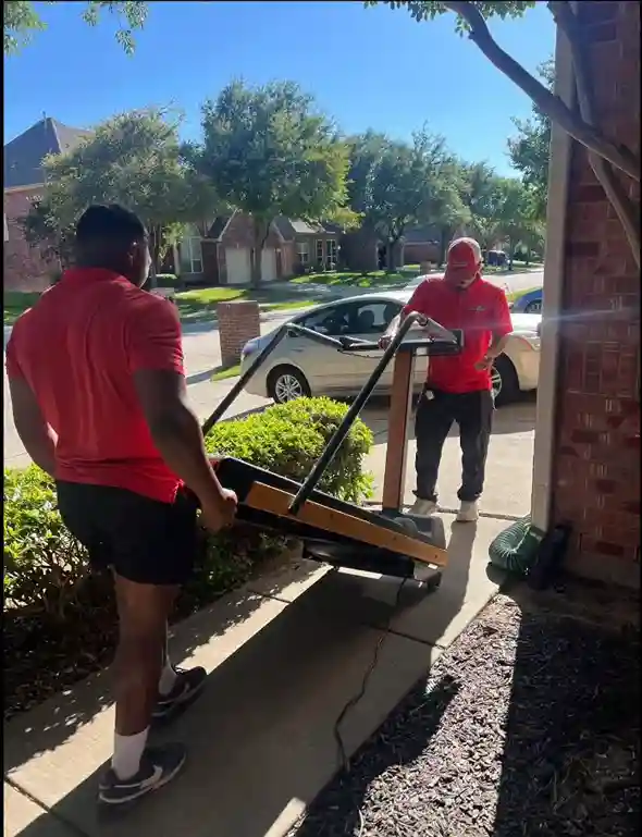 Junk Quest crew removing a treadmill from a North Dallas home for exercise equipment removal